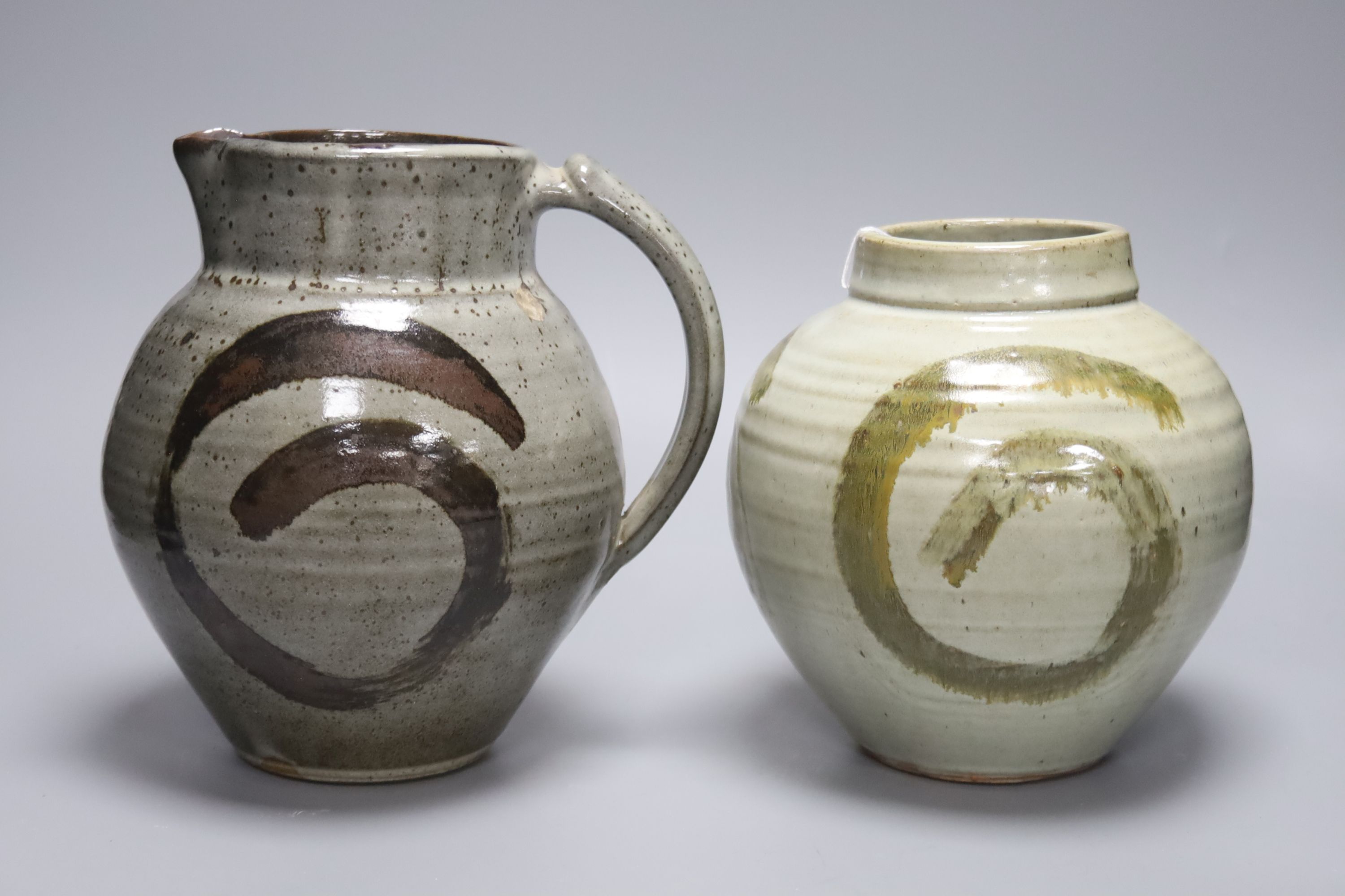 Clare Sutcliffe. A pottery jug and a similar vase, tallest 22cm